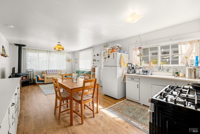 2855 Old Gravenstein Hwy, Sebastopol, CA 95472 - kitchen with freestanding refrigerator, range with gas stovetop, a sink, and plenty of natural light