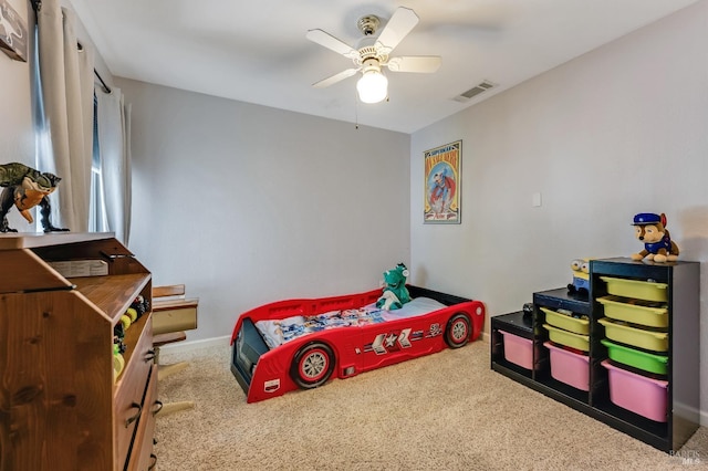 carpeted bedroom with baseboards, ceiling fan, and visible vents