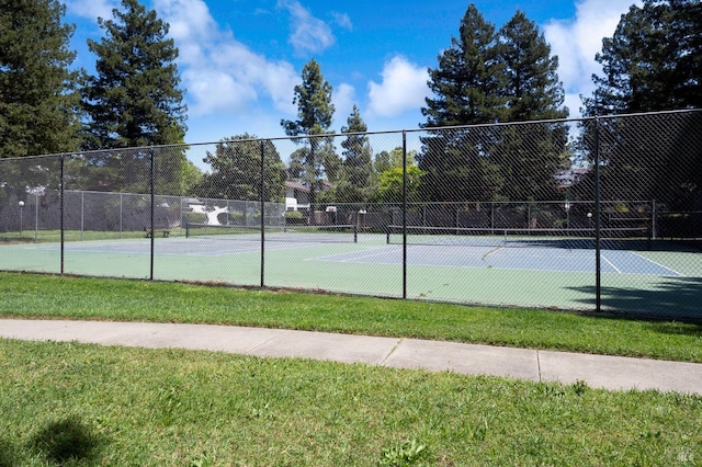 view of sport court featuring fence