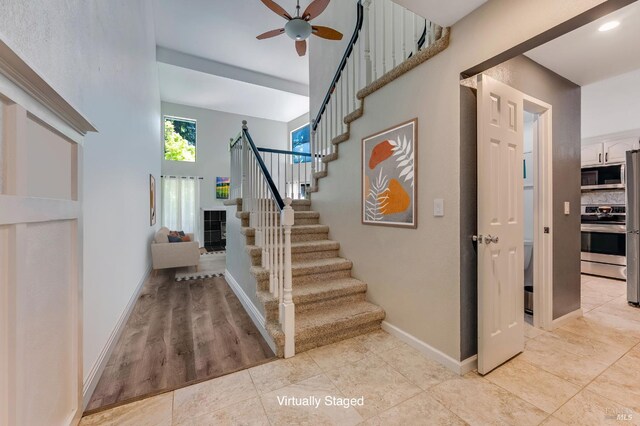 2204 Marylyn Cir, Petaluma, CA 94954 - living area featuring a high ceiling, plenty of natural light, wood finished floors, and a tile fireplace
