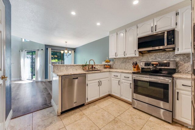 2204 Marylyn Cir, Petaluma, CA 94954 - kitchen with stainless steel appliances, a peninsula, decorative backsplash, white cabinets, and recessed lighting