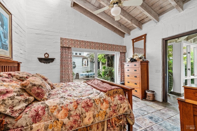 bedroom with stone tile floors, lofted ceiling with beams, multiple windows, and wood ceiling