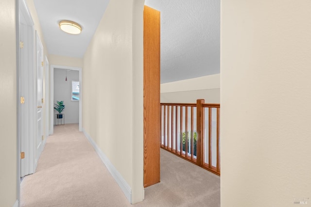 hallway featuring carpet floors and baseboards