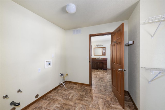 laundry area with washer hookup, laundry area, stone finish flooring, hookup for a gas dryer, and baseboards