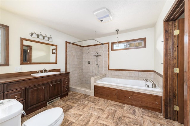 bathroom with a garden tub, vanity, visible vents, toilet, and tiled shower