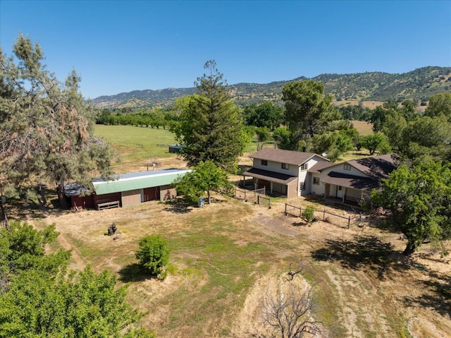 birds eye view of property with a mountain view and a rural view