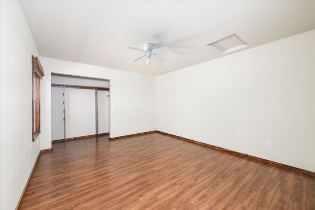 unfurnished bedroom featuring baseboards, ceiling fan, a closet, and wood finished floors