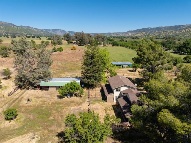 drone / aerial view featuring a mountain view and a rural view