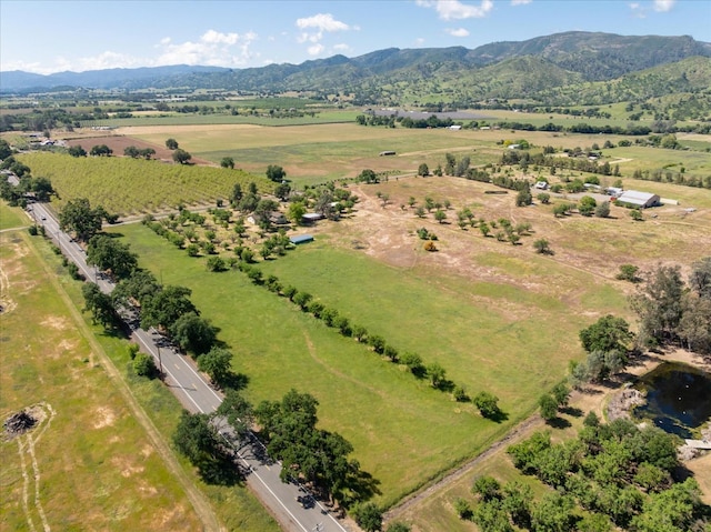 drone / aerial view featuring a mountain view and a rural view