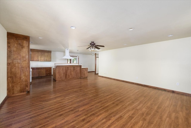 unfurnished living room featuring baseboards, ceiling fan, recessed lighting, and dark wood-type flooring