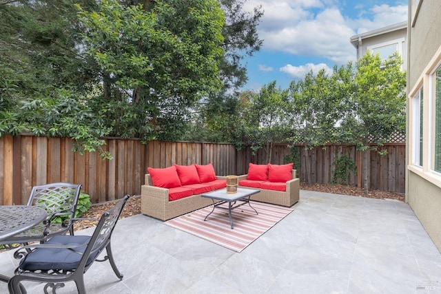 view of patio / terrace with an outdoor living space and a fenced backyard
