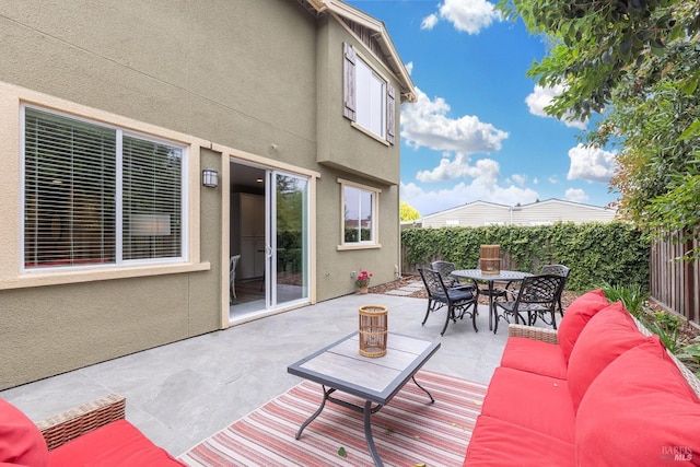 view of patio with outdoor dining area, a fenced backyard, and an outdoor hangout area