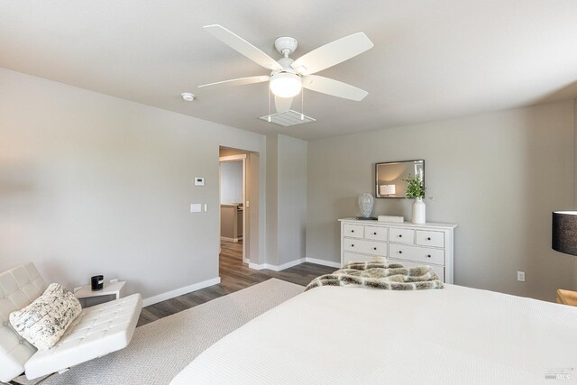 bedroom with dark wood-style flooring, baseboards, visible vents, and ceiling fan