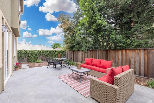 view of patio with an outdoor hangout area, outdoor dining area, and a fenced backyard