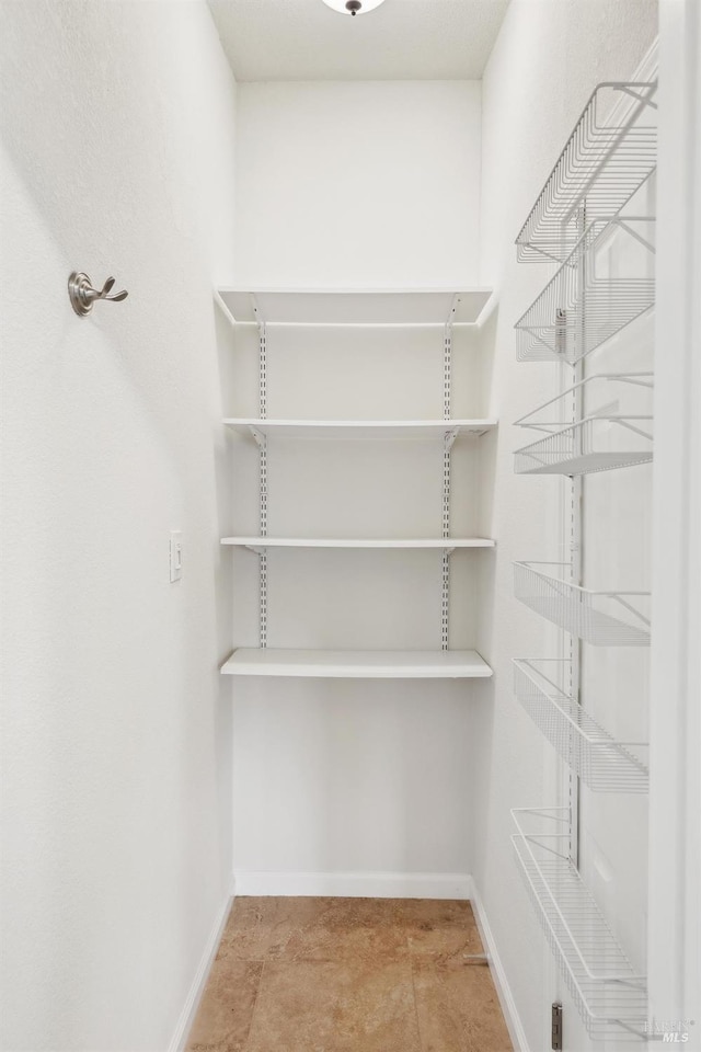 walk in closet with tile patterned flooring