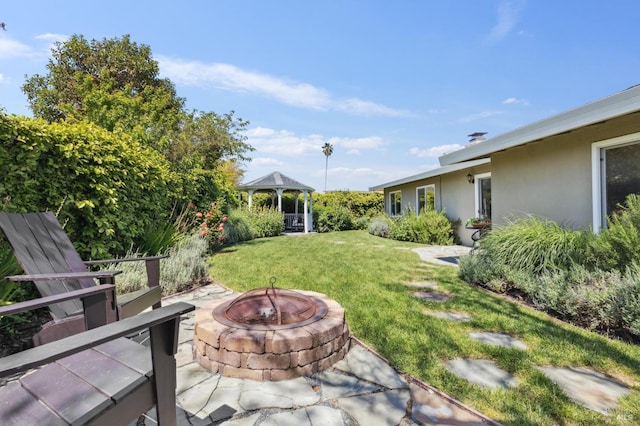 view of yard with a gazebo and an outdoor fire pit