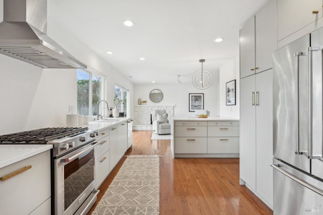 9 Monroe Ct, Novato, CA 94947 - kitchen with wall chimney range hood, stainless steel appliances, a sink, and modern cabinets