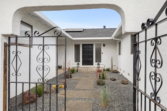 9 Monroe Ct, Novato, CA 94947 - entrance to property featuring a gate, a shingled roof, roof mounted solar panels, and stucco siding