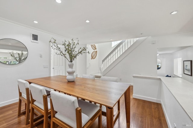 dining space featuring crown molding, recessed lighting, and wood finished floors