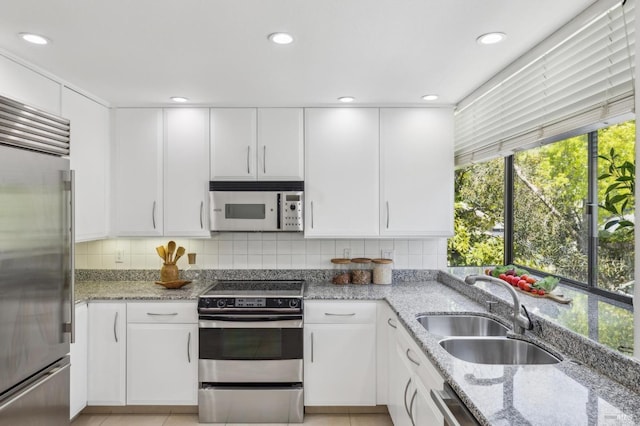 kitchen featuring a sink, appliances with stainless steel finishes, and white cabinets