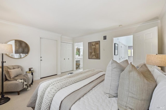carpeted bedroom with ornamental molding and connected bathroom