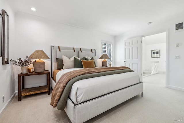 bedroom featuring crown molding, baseboards, light carpet, and visible vents