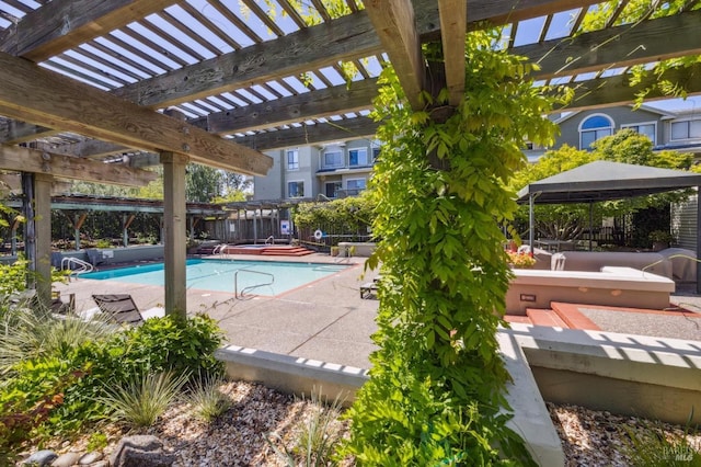 pool featuring a patio, a pergola, and a gazebo