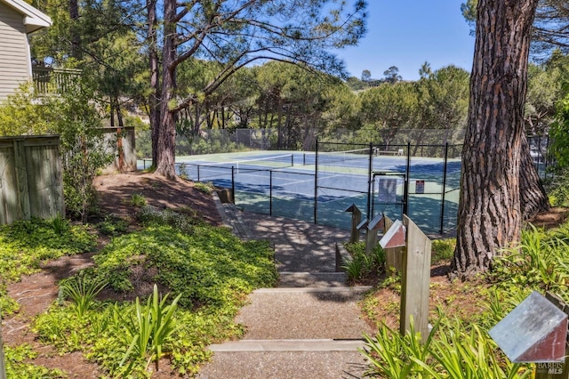 view of tennis court featuring fence