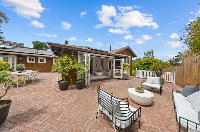 view of patio with fence, outdoor dining area, and an outdoor hangout area