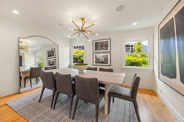 dining area with baseboards, light wood-style flooring, and a chandelier