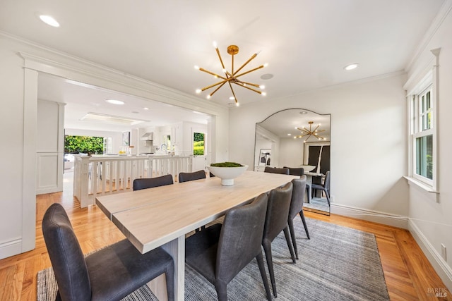 dining area featuring an inviting chandelier, baseboards, plenty of natural light, and light wood-style floors