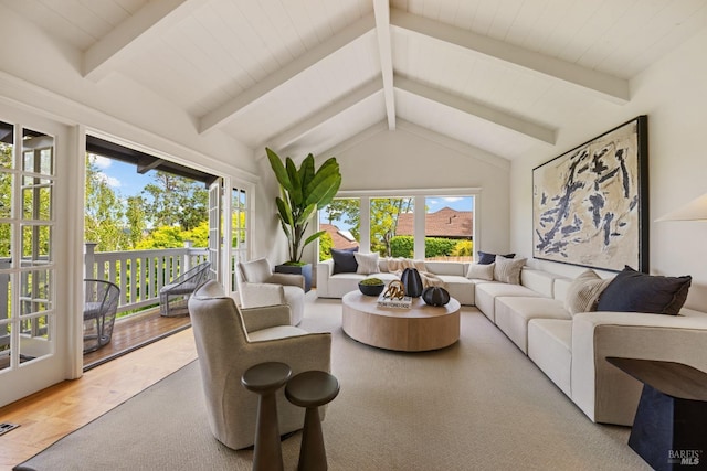 living room with vaulted ceiling with beams