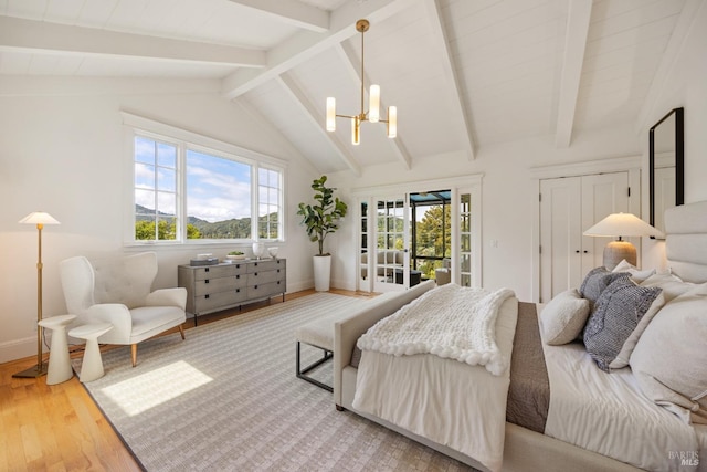 bedroom with access to outside, an inviting chandelier, baseboards, vaulted ceiling with beams, and wood finished floors
