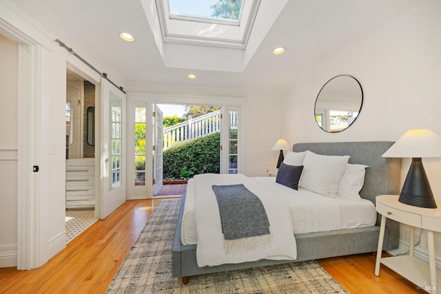 bedroom with recessed lighting, access to exterior, and wood finished floors
