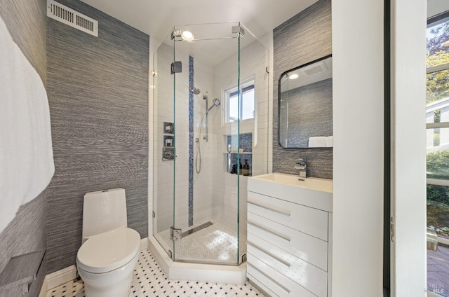 full bath with vanity, a stall shower, toilet, and visible vents