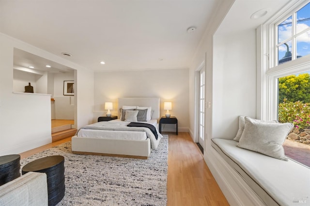 bedroom featuring recessed lighting, baseboards, multiple windows, and light wood finished floors