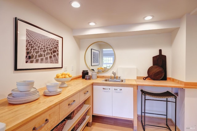 interior space featuring a sink, light wood finished floors, and recessed lighting