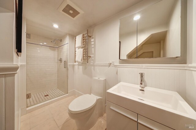 full bathroom featuring visible vents, a shower stall, a wainscoted wall, toilet, and a decorative wall