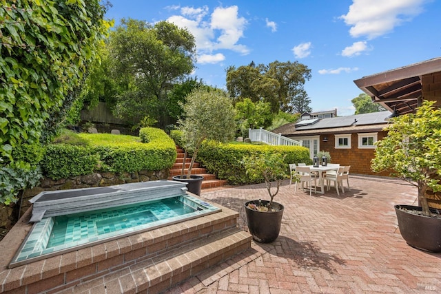 view of pool featuring outdoor dining area, an outdoor hot tub, stairs, and a patio