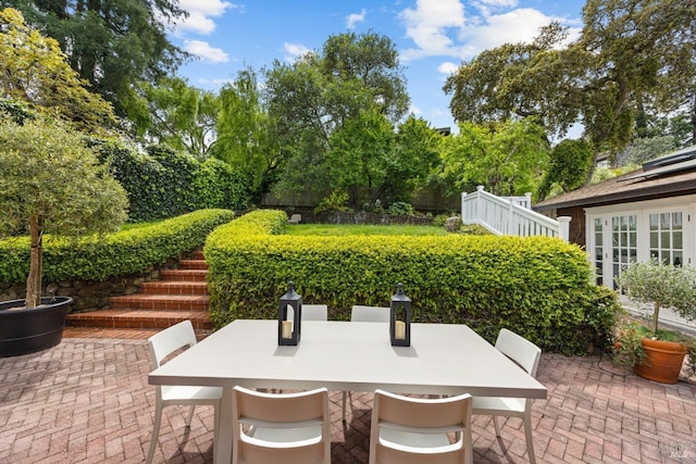 view of patio with stairway and outdoor dining space