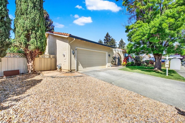 3432 Norwalk Pl, Fairfield, CA 94534 - view of front of property featuring stucco siding, a tiled roof, a garage, fence, and concrete driveway