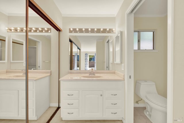 3432 Norwalk Pl, Fairfield, CA 94534 - bathroom with two vanities, toilet, ornamental molding, baseboards, and tile patterned floors