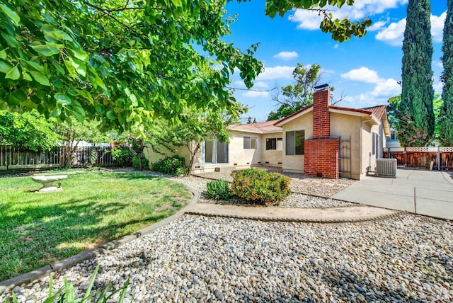 3432 Norwalk Pl, Fairfield, CA 94534 - rear view of house featuring stucco siding, a chimney, central AC unit, and a patio area