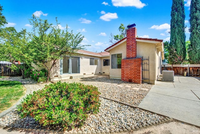 3432 Norwalk Pl, Fairfield, CA 94534 - rear view of property featuring stucco siding, a patio, fence, central AC unit, and a chimney