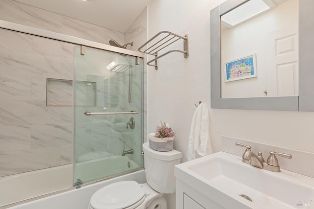 full bathroom featuring vanity, toilet, and shower / bath combination with glass door