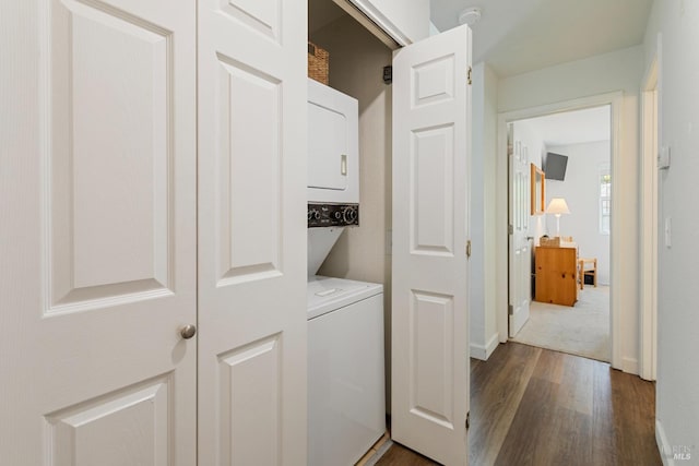 clothes washing area with laundry area, stacked washer and dryer, and dark wood-type flooring