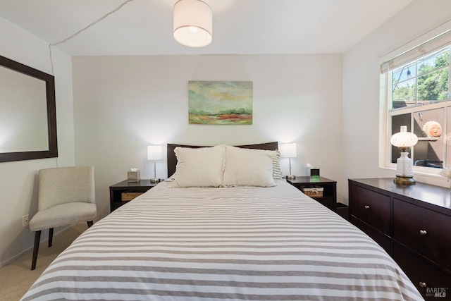 carpeted bedroom featuring baseboards