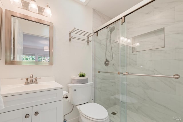 full bathroom featuring vanity, a stall shower, and toilet