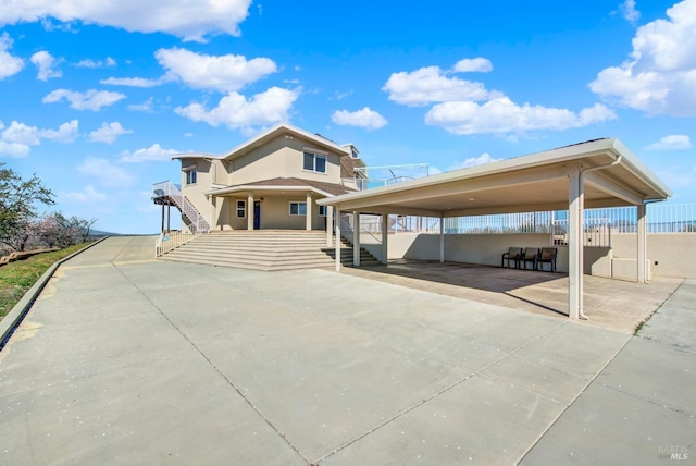 view of front of property featuring stairs and fence