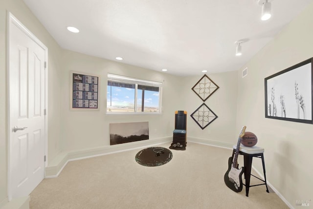 exercise room with baseboards, carpet flooring, and visible vents